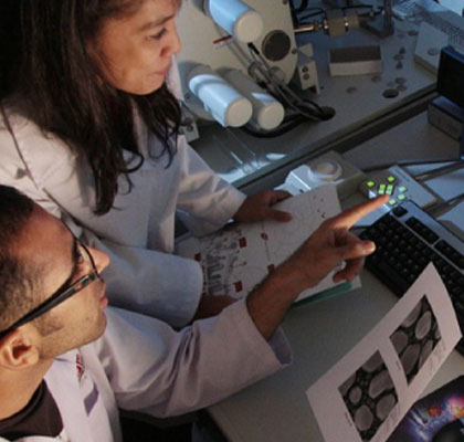 A lady and man in lab coats working